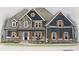 Charming home featuring stone accents, symmetrical windows, and wood trim accents over a welcoming porch at 133 West Lake Blvd, Carrollton, GA 30116