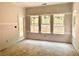 Living room features drywall ready for paint with views from multiple windows and a glass door at 133 West Lake Blvd, Carrollton, GA 30116