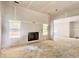 Living room featuring drywall ready for paint with a fireplace and multiple windows at 133 West Lake Blvd, Carrollton, GA 30116