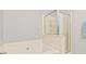 Bright bathroom featuring a separate shower, soaking tub and neutral wall colors at 2457 Birkhall Way # 2457, Lawrenceville, GA 30043