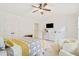 Well-lit bedroom includes a TV, ensuite access, and dual closets for ample storage at 2457 Birkhall Way # 2457, Lawrenceville, GA 30043