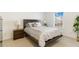 Serene bedroom features a wooden bed frame, large window, and decorative lamps at 2457 Birkhall Way # 2457, Lawrenceville, GA 30043