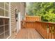 Inviting deck area for outdoor relaxing, complemented by natural light and a wood railing at 2457 Birkhall Way # 2457, Lawrenceville, GA 30043