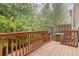 Cozy wooden deck offers a private outdoor space surrounded by lush greenery at 2457 Birkhall Way # 2457, Lawrenceville, GA 30043