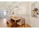Light-filled dining room with stylish chandelier and built-in shelving with wine rack at 2457 Birkhall Way # 2457, Lawrenceville, GA 30043
