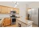 Bright kitchen featuring granite countertops, stainless steel appliances, and a kitchen island at 2457 Birkhall Way # 2457, Lawrenceville, GA 30043