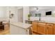 Open kitchen with granite countertops, stainless steel dishwasher, and a view to the dining room at 2457 Birkhall Way # 2457, Lawrenceville, GA 30043