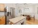Open kitchen with granite countertops, stainless steel refrigerator, and a view to the dining room at 2457 Birkhall Way # 2457, Lawrenceville, GA 30043