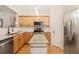 Bright kitchen featuring granite countertops, stainless steel appliances, and a kitchen island at 2457 Birkhall Way # 2457, Lawrenceville, GA 30043