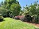 Manicured lawn featuring mature trees and lush plantings at 3753 Honey Pot Ne Way, Marietta, GA 30066
