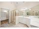 Bright bathroom boasts a walk-in glass shower, double sinks with white cabinets, and walk in closet at 3753 Honey Pot Ne Way, Marietta, GA 30066
