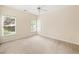 Bright bedroom featuring plush carpeting, natural light from two windows and door, and a ceiling fan at 3753 Honey Pot Ne Way, Marietta, GA 30066