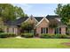 Traditional brick home with a well-manicured lawn and mature landscaping at 3753 Honey Pot Ne Way, Marietta, GA 30066