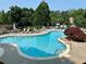 Sparkling community pool surrounded by lounge chairs, mature trees, and a secure fence at 3753 Honey Pot Ne Way, Marietta, GA 30066