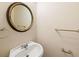 Charming powder room features a pedestal sink, decorative mirror, and stylish fixtures at 3753 Honey Pot Ne Way, Marietta, GA 30066