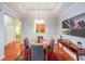 Beautiful dining room features decorative lighting, chair rail molding and hardwood floors at 3916 Abbott Way # 2, Powder Springs, GA 30127
