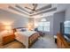 Relaxing bedroom with tray ceiling, bright windows, and wooden furniture at 3916 Abbott Way # 2, Powder Springs, GA 30127