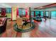 Open basement area with a dining table, gym equipment, and comfortable seating at 3985 Loch Highland Ne Pass, Roswell, GA 30075