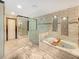 Bright bathroom with a glass shower, soaking tub, and tiled walls at 3985 Loch Highland Ne Pass, Roswell, GA 30075