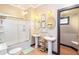 Modern bathroom features double sinks, a glass-enclosed shower, and stylish decor, creating a spa-like atmosphere at 3985 Loch Highland Ne Pass, Roswell, GA 30075