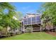 Multi-level home showcasing the back decks, screened-in porch, and lush landscaping at 3985 Loch Highland Ne Pass, Roswell, GA 30075