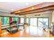 Bright gym features exercise equipment, hardwood floors, exposed beams, and access to a balcony for workouts with a view at 3985 Loch Highland Ne Pass, Roswell, GA 30075