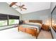 Bright main bedroom featuring a vaulted ceiling, wooden bed frame and large windows with a view to the exterior at 3985 Loch Highland Ne Pass, Roswell, GA 30075