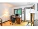 Well-lit office space with hardwood floors, a large desk, and an exterior door at 3985 Loch Highland Ne Pass, Roswell, GA 30075