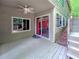 Covered patio with ceiling fan, sliding glass doors, and an adjacent staircase at 3985 Loch Highland Ne Pass, Roswell, GA 30075