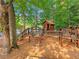 Wooden playground set with a treehouse, slide, and climbing features for  at 3985 Loch Highland Ne Pass, Roswell, GA 30075