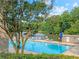Community pool with lounge chairs and lush greenery, ideal for relaxation at 3985 Loch Highland Ne Pass, Roswell, GA 30075