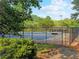 Community tennis court with a shaded pavilion, surrounded by mature trees at 3985 Loch Highland Ne Pass, Roswell, GA 30075