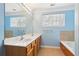 Bright bathroom featuring a double sink vanity, large mirror, and a window for natural light at 577 Reed Se St, Atlanta, GA 30312