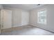 This bedroom has two closets and a window with a view to the outdoors at 2140 Deer Trl, Suwanee, GA 30024