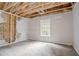 Bedroom under repair with exposed structure and window at 2140 Deer Trl, Suwanee, GA 30024