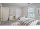 Bright bedroom featuring two twin beds, a large window, and ample closet space at 2140 Deer Trl, Suwanee, GA 30024