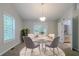 Inviting dining room featuring a modern light fixture and view to the kitchen at 2140 Deer Trl, Suwanee, GA 30024