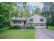 Charming home featuring a covered front porch, attached two car garage, and lush landscaping at 2140 Deer Trl, Suwanee, GA 30024