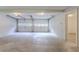 Spacious two-car garage with white doors and ample lighting at 2140 Deer Trl, Suwanee, GA 30024