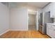 Bright kitchen features wood floors, white cabinets, and stainless steel refrigerator at 2140 Deer Trl, Suwanee, GA 30024