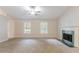 This open living room features recessed lighting, a fireplace, and large double windows at 2140 Deer Trl, Suwanee, GA 30024