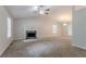 Open-concept living room features high ceilings, ceiling fan, and fireplace at 2140 Deer Trl, Suwanee, GA 30024