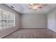 Large main bedroom with tray ceilings, fan, and plenty of space at 2140 Deer Trl, Suwanee, GA 30024