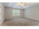 Spacious main bedroom with trey ceilings, ceiling fan, and a large window at 2140 Deer Trl, Suwanee, GA 30024