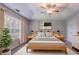 Main bedroom boasts a tray ceiling, neutral decor, and natural light at 2140 Deer Trl, Suwanee, GA 30024