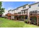 Townhome exteriors and decks are surrounded by a well-maintained green lawn, perfect for outdoor enjoyment at 3655 Chattahoochee Summit Se Dr # 16, Atlanta, GA 30339