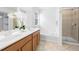 Elegant bathroom with a dual sink vanity, soaking tub, and tiled shower with glass door at 3655 Chattahoochee Summit Se Dr # 16, Atlanta, GA 30339