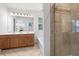 Bright bathroom featuring a dual sink vanity, soaking tub, and tiled shower with glass doors at 3655 Chattahoochee Summit Se Dr # 16, Atlanta, GA 30339