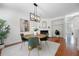 Cozy dining area with fireplace, modern chandelier, and hardwood floors at 3655 Chattahoochee Summit Se Dr # 16, Atlanta, GA 30339