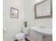 Charming half bath features a pedestal sink, toilet, and decorative mirror and art at 3655 Chattahoochee Summit Se Dr # 16, Atlanta, GA 30339